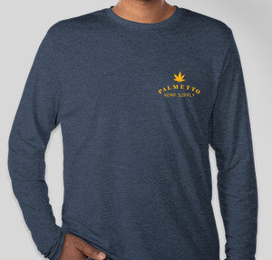 Person in a long sleeve navy colored t-shirt with a yellow Palmetto Hemp Supply logo on the front top left side of the shirt.